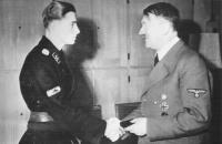 Adolf_Hitler_awards_Jochen_Peiper_RKE_in_Wolfschanze_feb1944.jpg