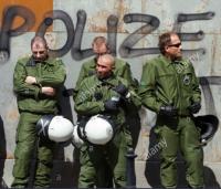 a-group-of-german-riot-police-stand-in-front-of-a-wall-spray-painted-B2FWRW (460x392).jpg